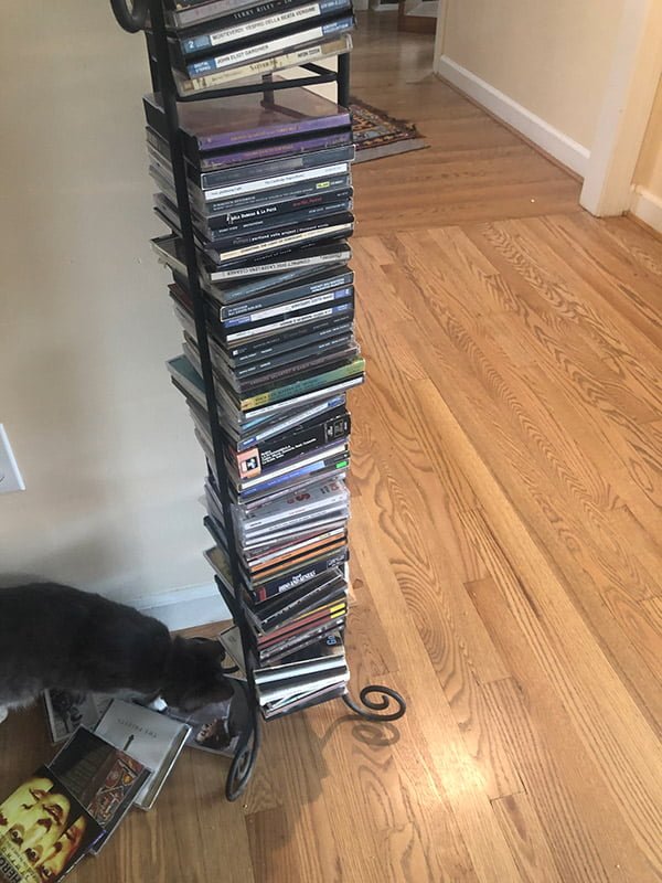 Music albums stacked in a CD tower.